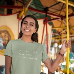 The Cost Of Peace Sage Tee 5 The Cost Of Peace Sage Tee -Aurora Style Shop ringer t shirt mockup of a woman standing in a carousel 27277 777891